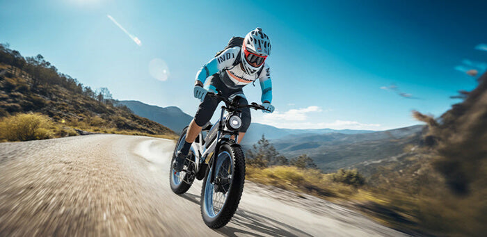 a man riding a duotts n26 1500w electric bike on the sandy road