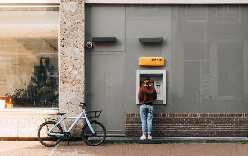 a woman stands near one e-bike