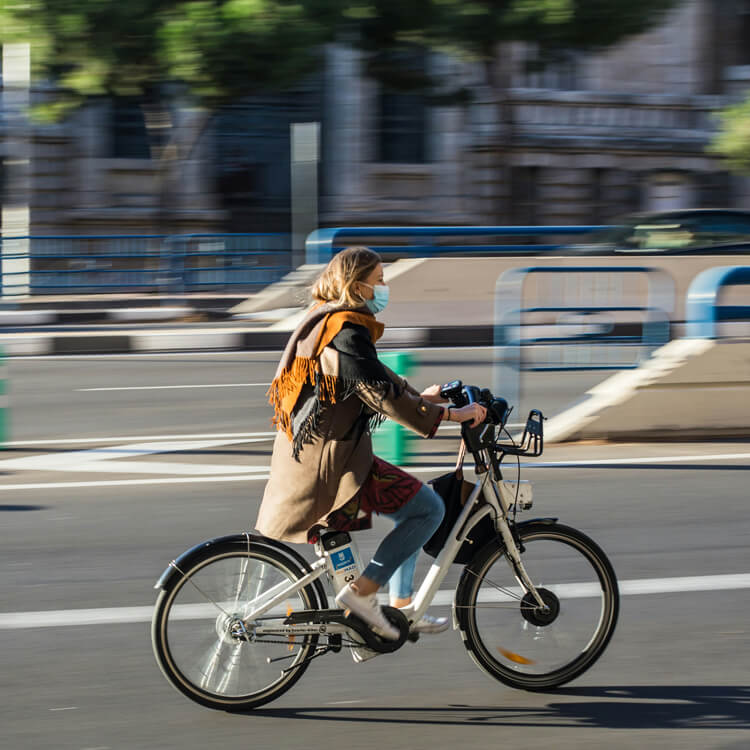 a woman rides an e-bike on the road